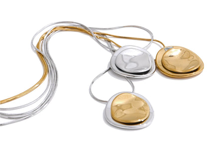 Gold and silver necklaces on a white background