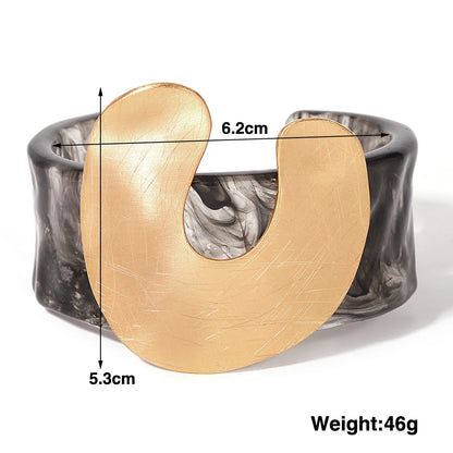 Gold and black marbled bracelet with measurements and weight displayed