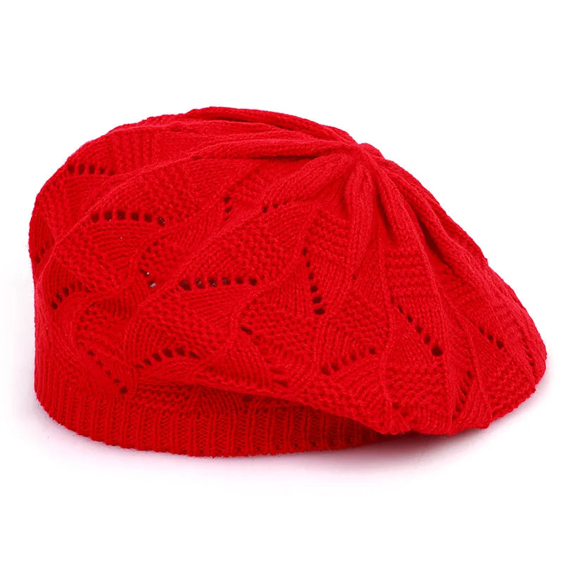 Red knitted beret on a white background