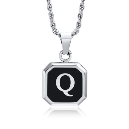 Silver necklace with a black pendant featuring the letter 'Q' on a white background