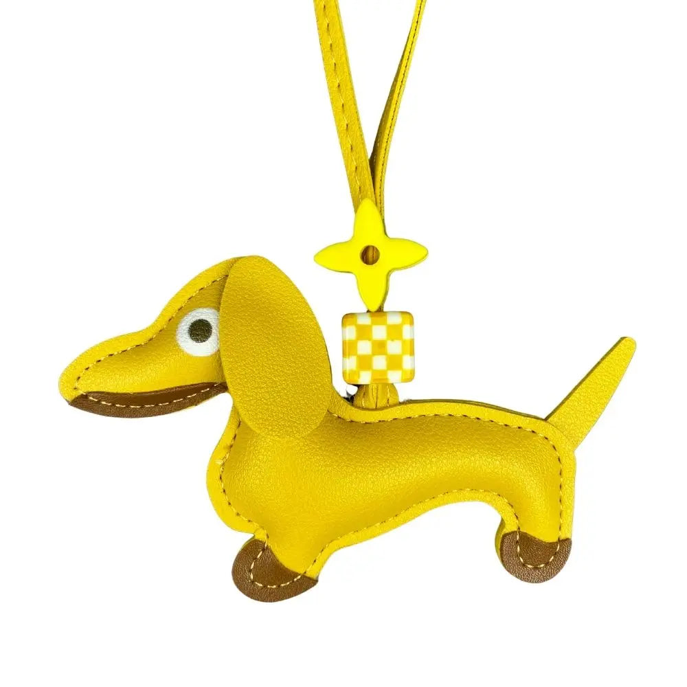 Yellow dachshund-shaped keychain with a checkered tag on a white background