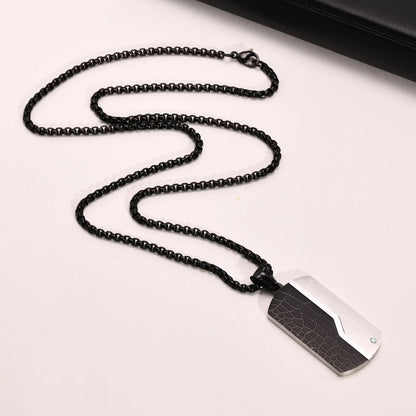 Black beaded necklace with a rectangular pendant on a white background