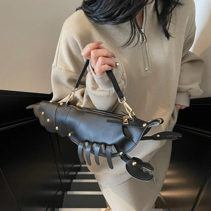 Person holding a unique handbag with claw-like design