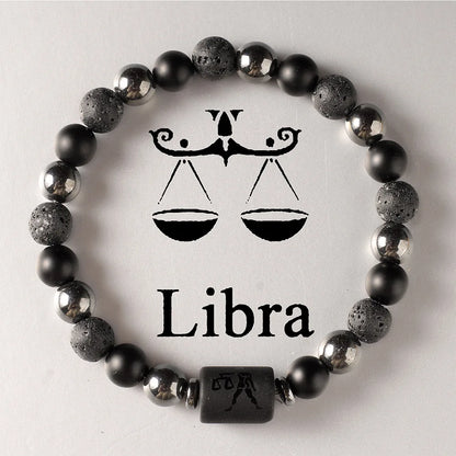 Black beaded bracelet with Libra zodiac symbol on a light grey background