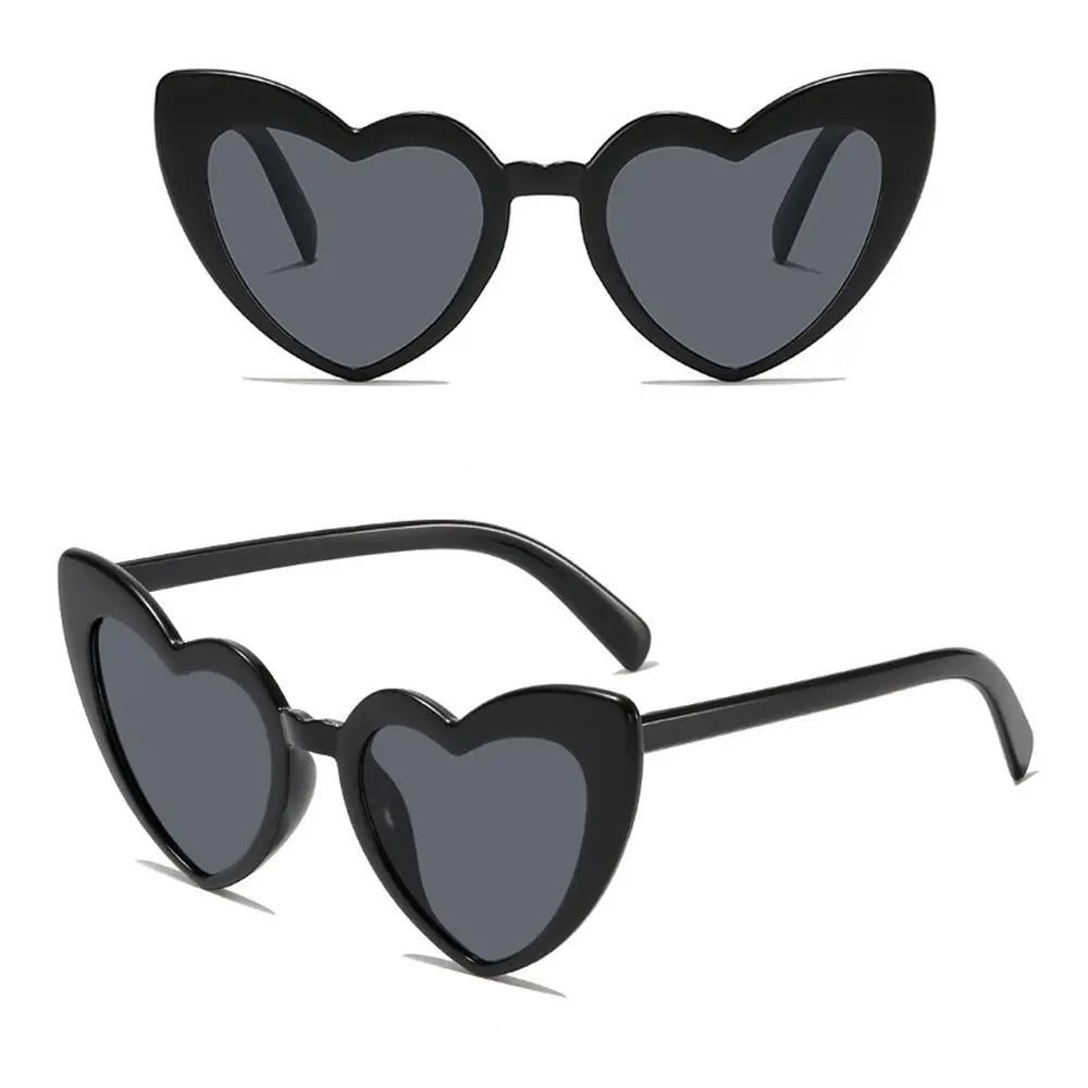 Heart-shaped sunglasses with black frames and dark lenses on a white background.