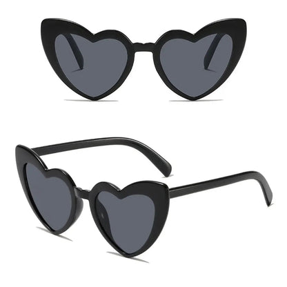 Heart-shaped sunglasses with black frames and dark lenses on a white background.