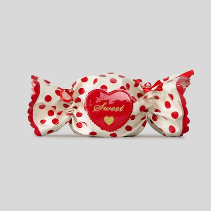 Candy shaped bag with red polka dot pattern on a grey background