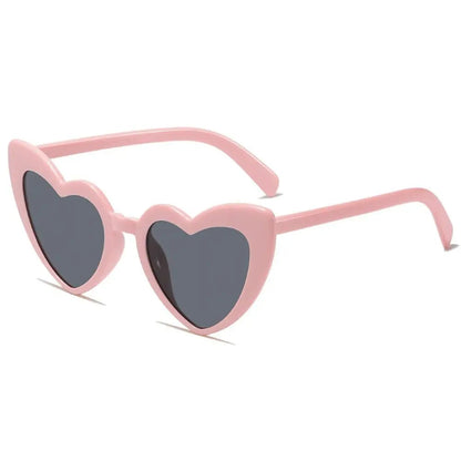 Heart-shaped pink sunglasses with dark lenses on a white background
