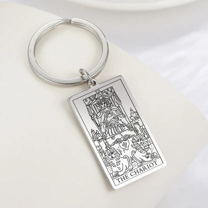 Keychain with 'The Chariot' tarot card design on a white surface