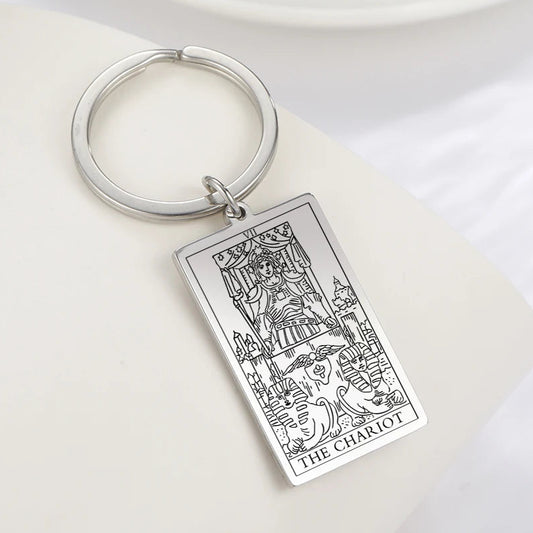 Keychain with 'The Chariot' tarot card design on a white surface