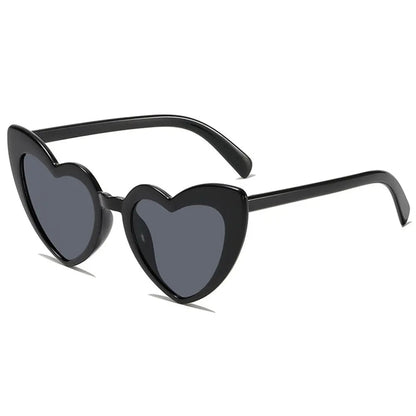 Heart-shaped sunglasses with black frame and dark lenses on a white background