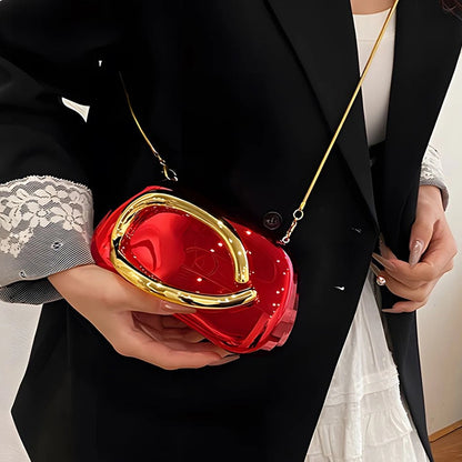 Person holding a red handbag with gold accents