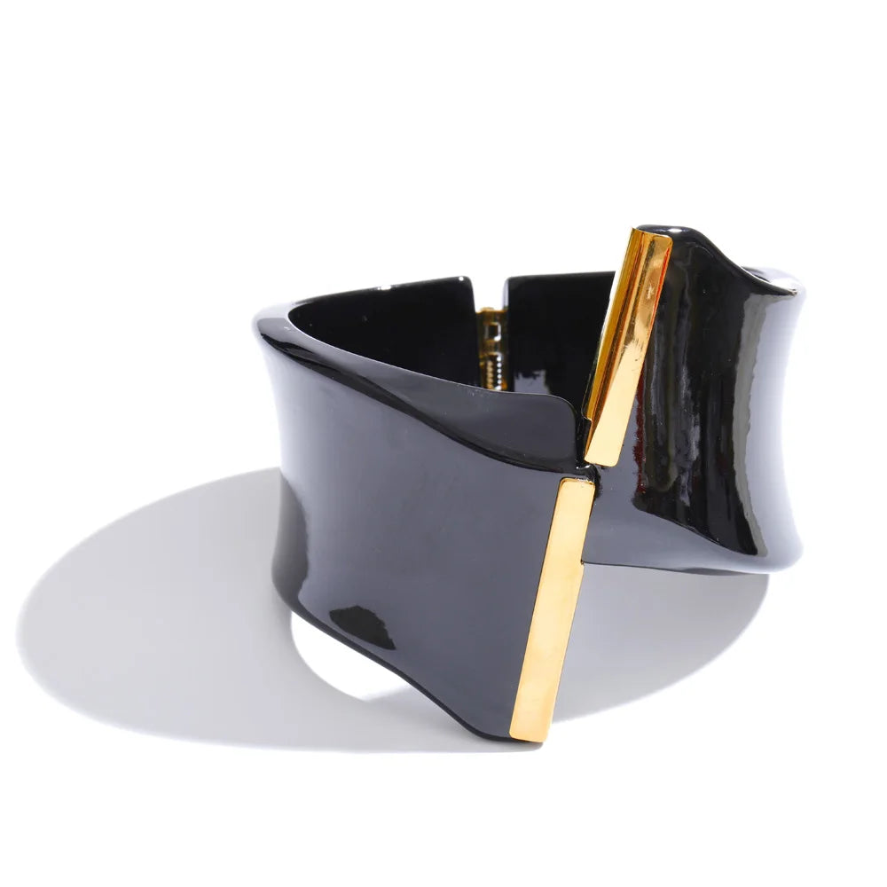 Black and gold bracelet on a white background
