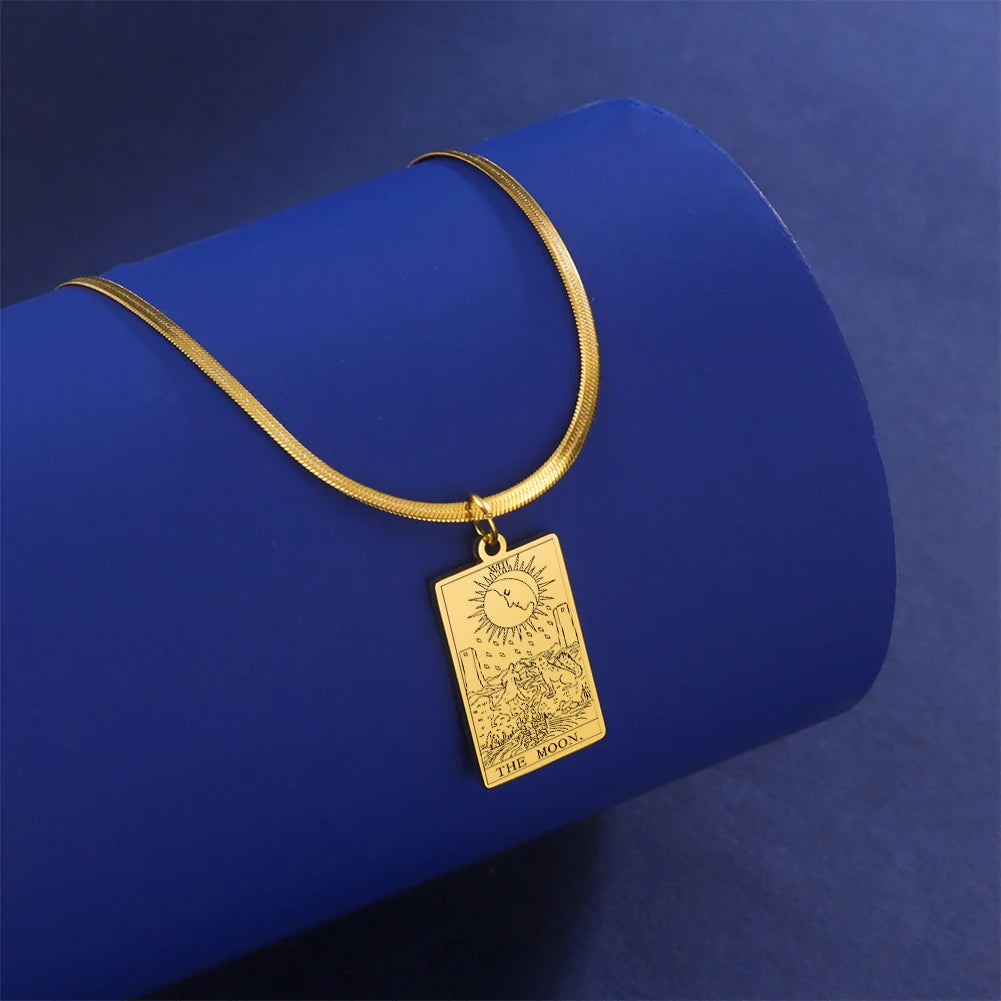 Gold necklace with a rectangular pendant on a blue background