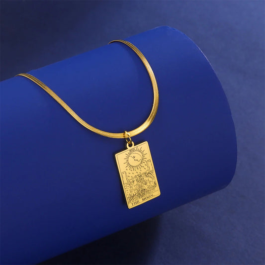 Gold necklace with a rectangular pendant on a blue background