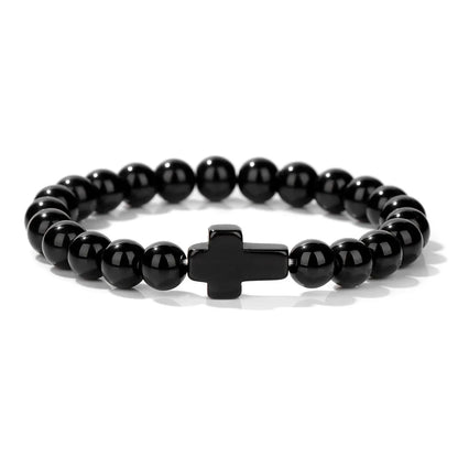 Black beaded bracelet with a cross charm on a white background