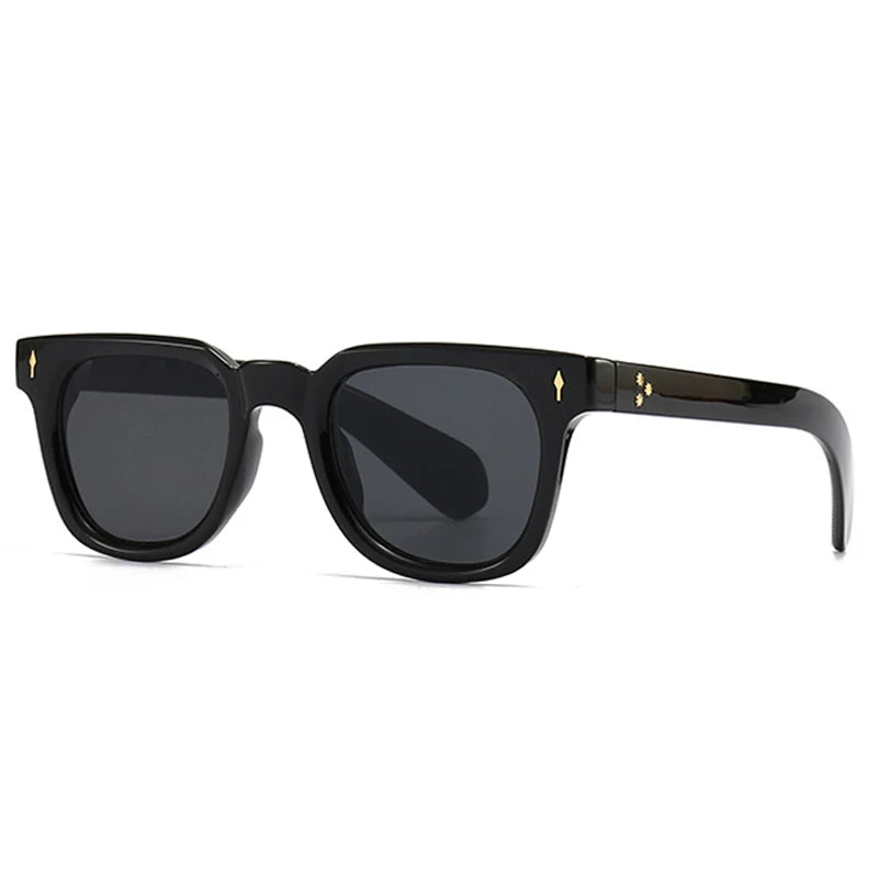 Black sunglasses with gold accents on a white background