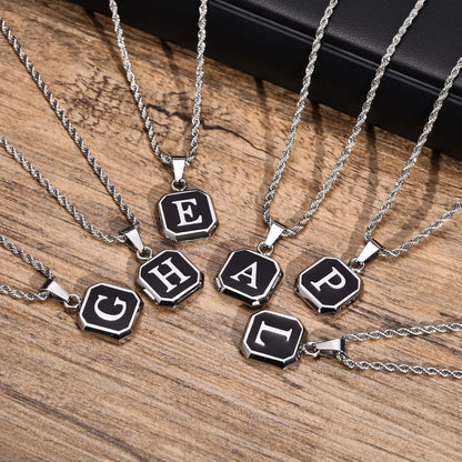 Necklaces with letter pendants on a wooden surface