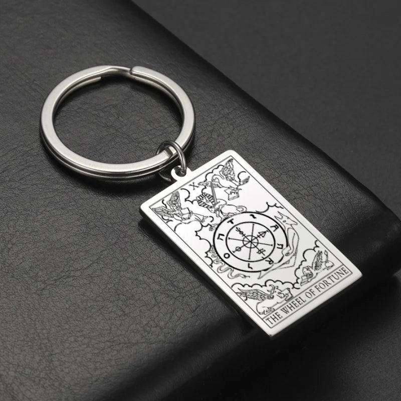 Keychain with tarot card design on a dark surface