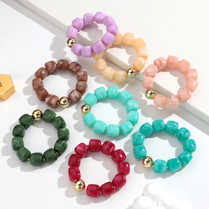 Set of colourful beaded bracelets on a white background
