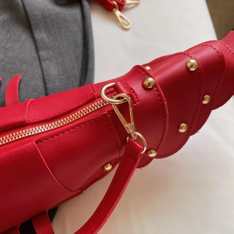 Red handbag with gold accents on a neutral background