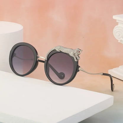 Sunglasses with decorative arm on a white surface with a blurred background
