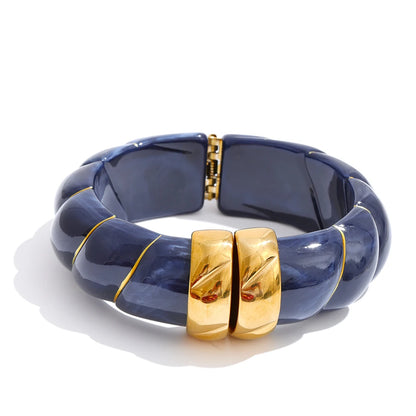 Blue bracelet with gold accents on a white background