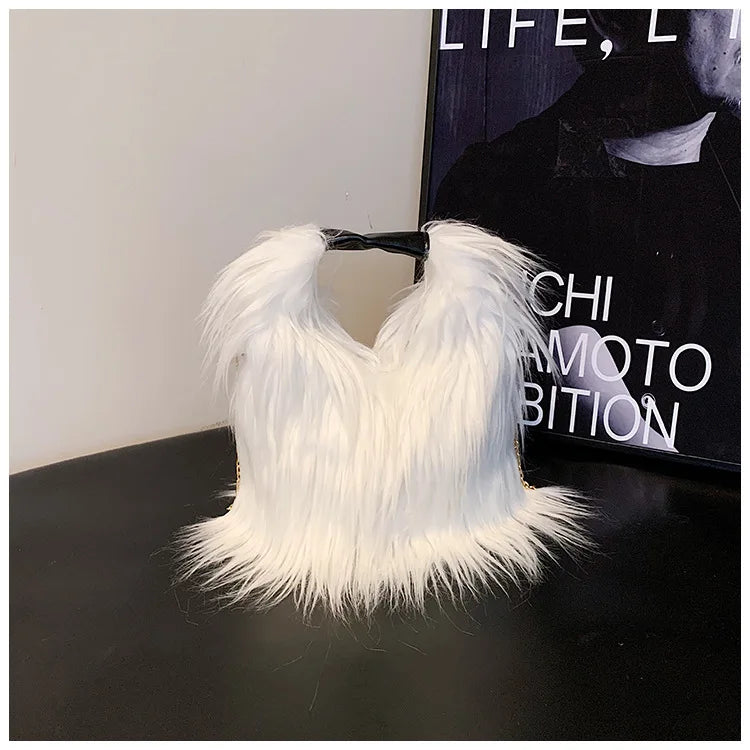 White feathered shoulder bag on a dark surface with a blurred background
