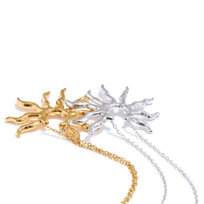 Two sun-shaped pendants on chains.