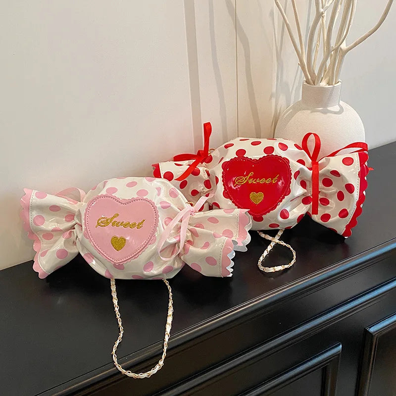 Two decorative bags with polka dot patterns and 'sweet' text on a dark surface.