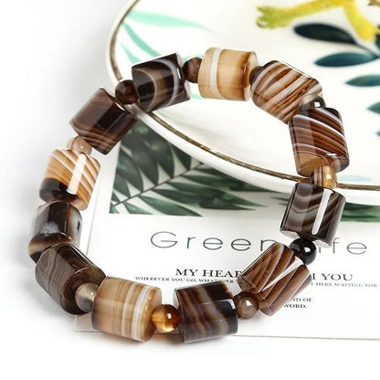 Beaded bracelet with brown and beige pattern on a magazine page