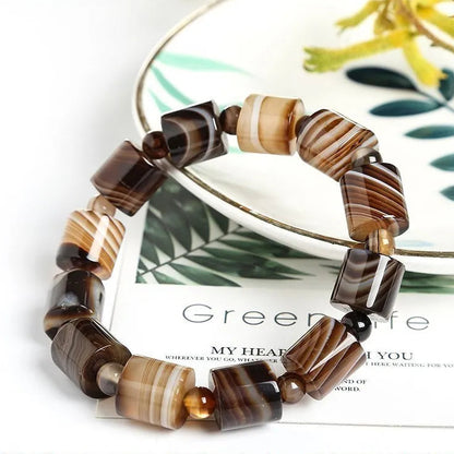 Beaded bracelet with brown and beige pattern on a magazine page