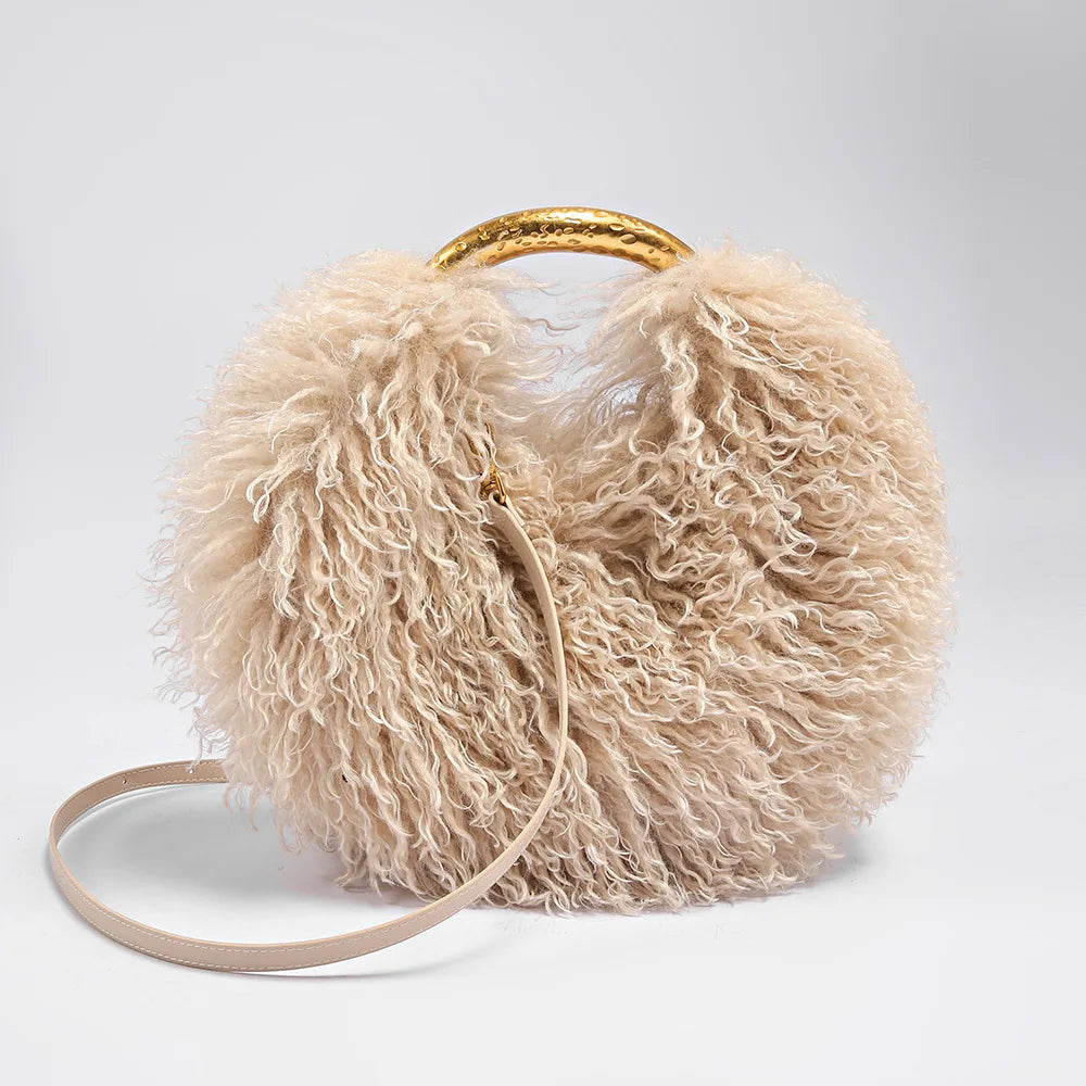 Beige fluffy handbag with a gold handle on a white background