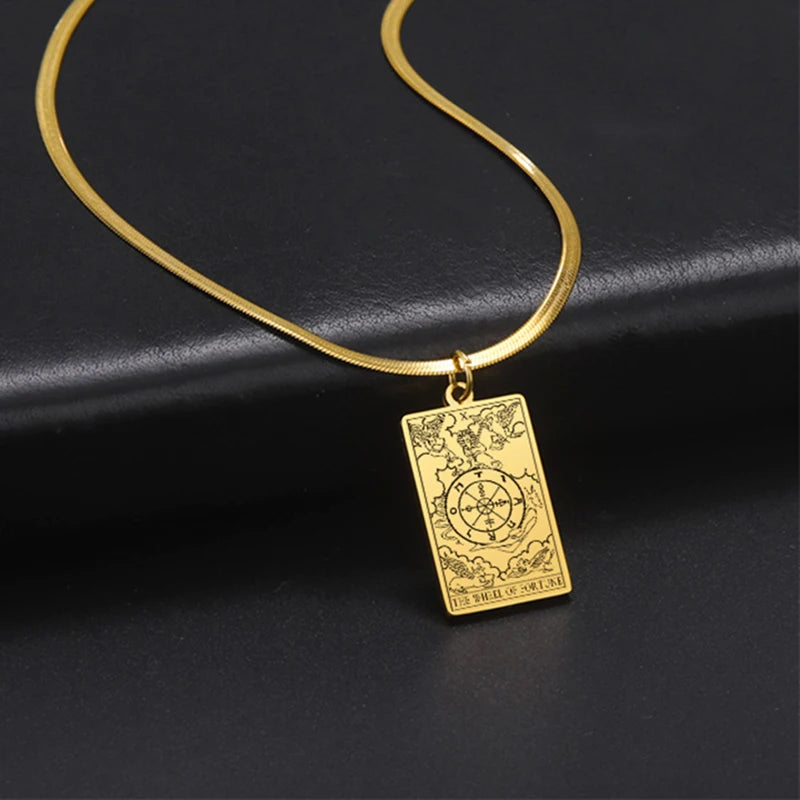 Gold necklace with a rectangular pendant on a black background