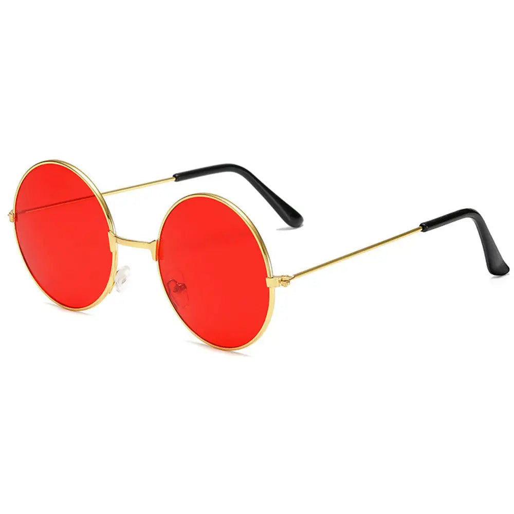Sunglasses with red lenses and gold frames on a white background