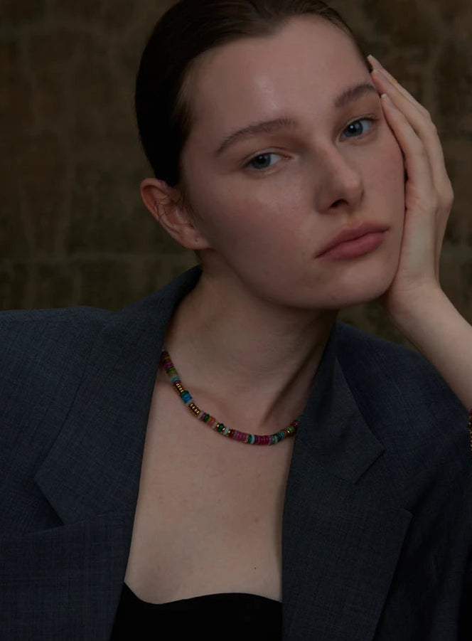Woman wearing a dark blazer on a textured background
