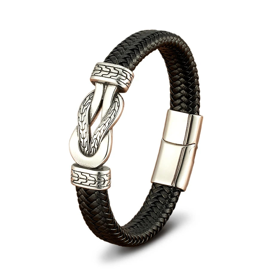Black braided leather bracelet with silver metal clasp on a white background