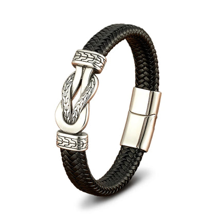 Black braided leather bracelet with silver metal clasp on a white background