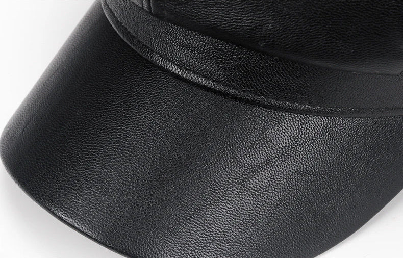 Close-up of a black leather cap on a white background