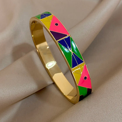 Colourful geometric-patterned bangle on a beige fabric background
