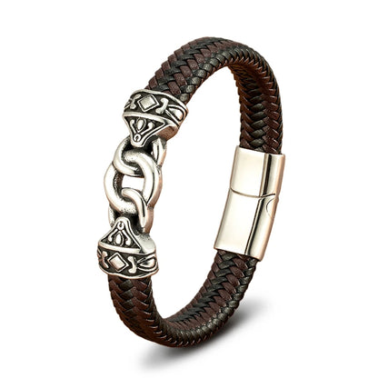Brown braided leather bracelet with silver Celtic knot design on a white background