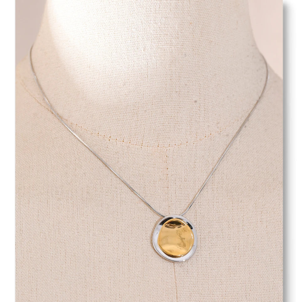 Necklace with a gold pendant on a beige background