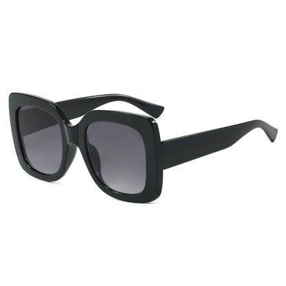 Black oversized square sunglasses with gradient grey lenses, shown at a three-quarter angle on a plain white background.