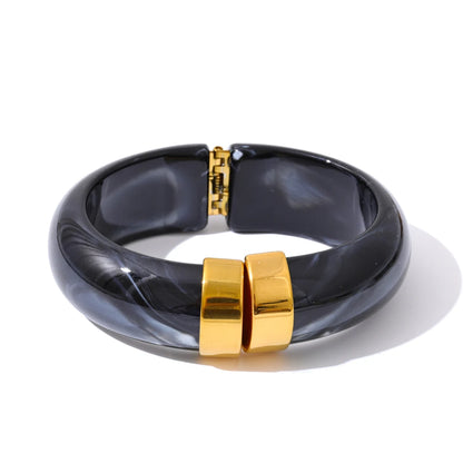Black and gold bracelet on a white background