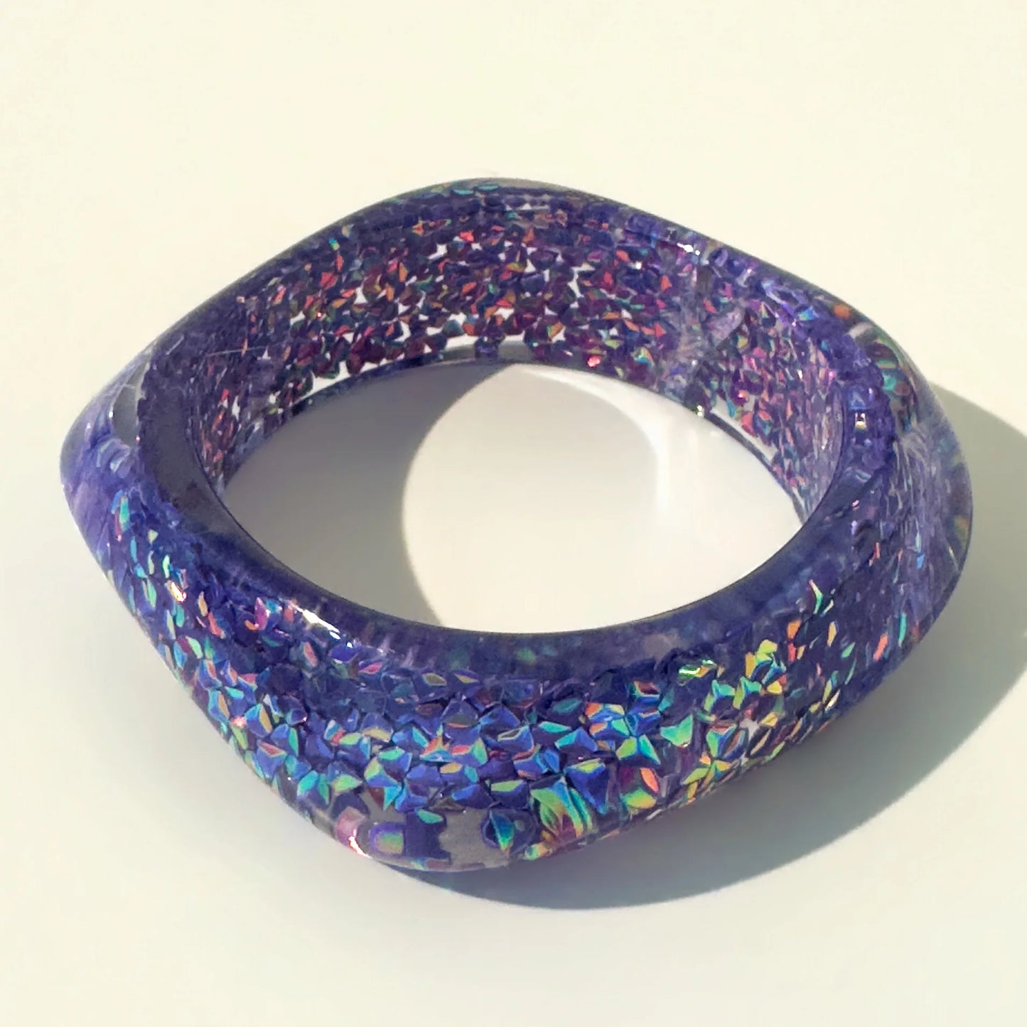 Multicoloured glittery bangle on a white background