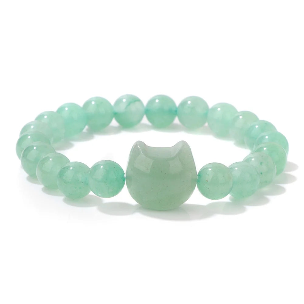 Green beaded bracelet with a cat-shaped charm on a white background