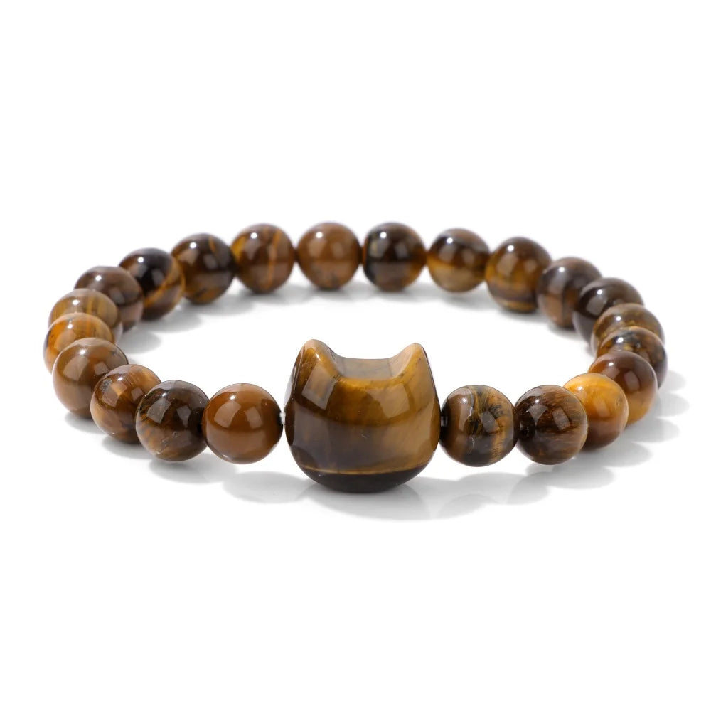 Brown beaded bracelet with a cat-shaped charm on a white background