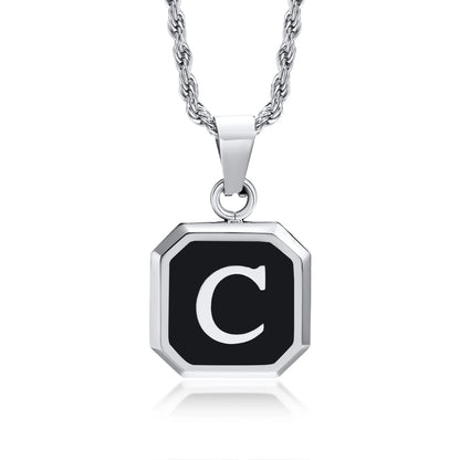 Silver necklace with a black octagonal pendant featuring the letter 'C' on a white background