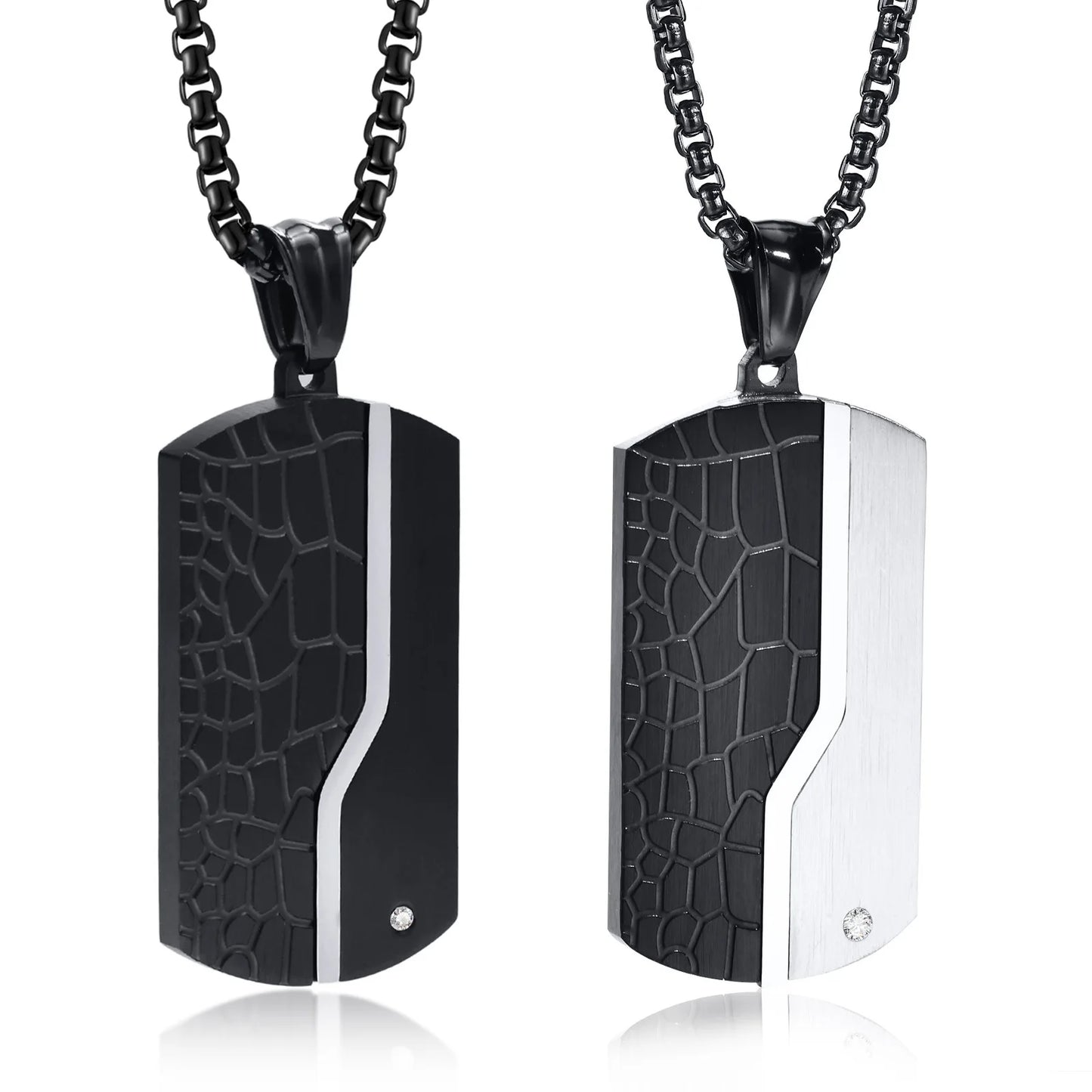Two black and silver patterned pendants on black chains against a white background