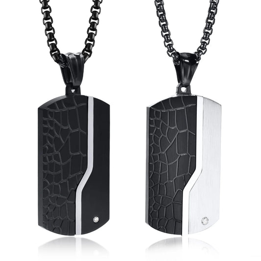 Two black and silver patterned pendants on black chains against a white background